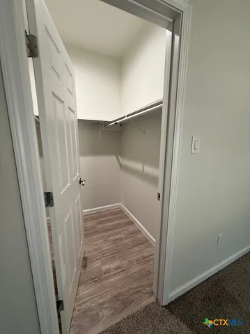 a view of a hallway view with wooden floor and staircase