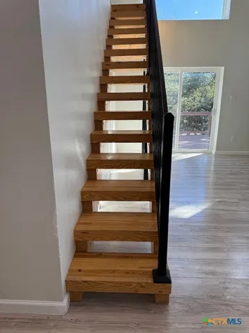 a view of an empty room and wooden floor