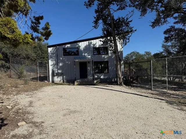 a view of house with snow on the road