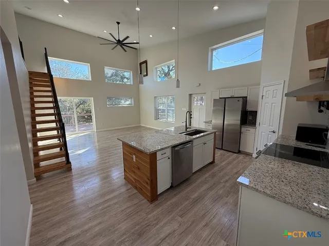 a kitchen with stainless steel appliances granite countertop a stove and a refrigerator