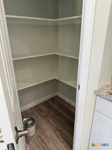 a view of closet area with empty racks