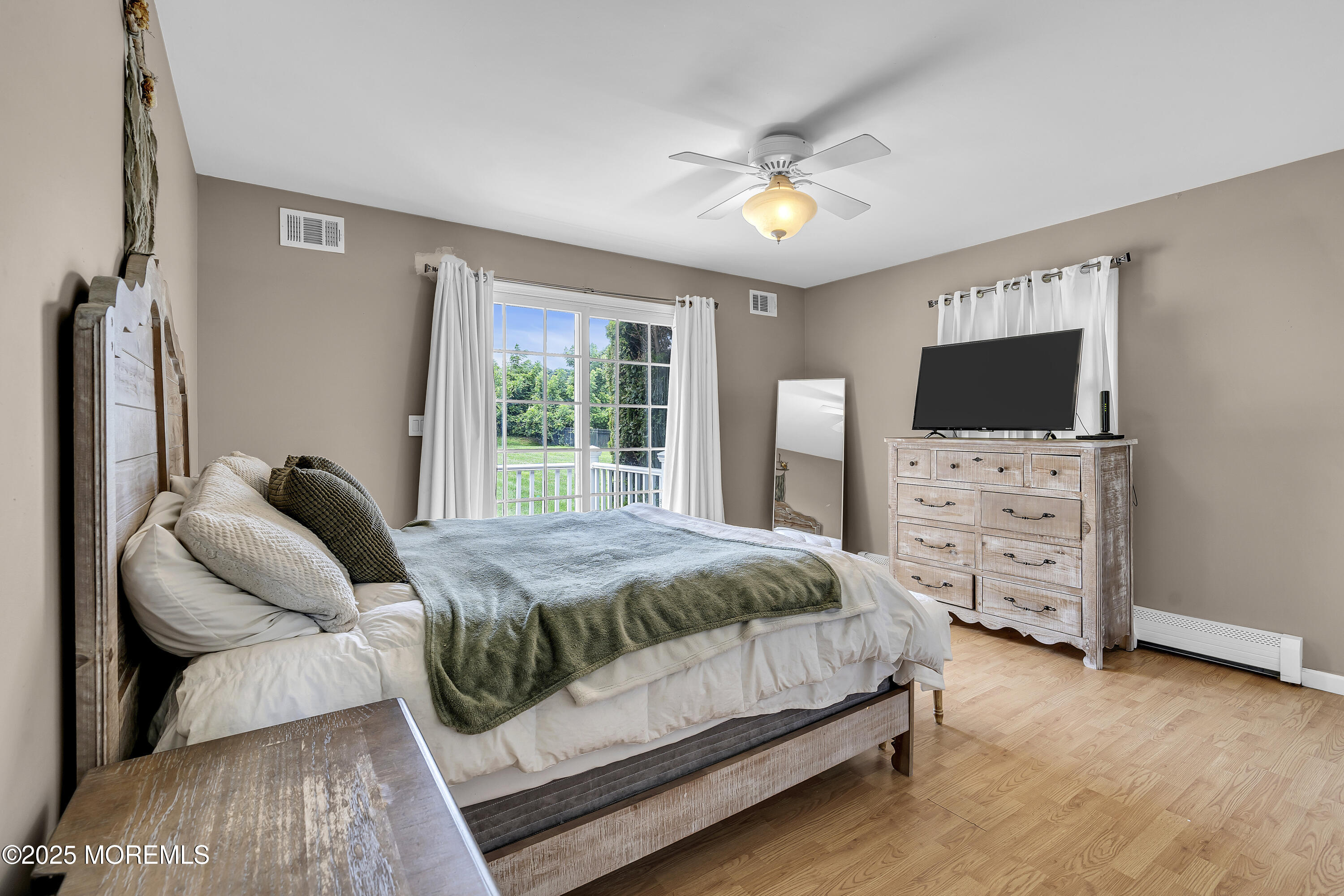 40 Centerville Road Holmdel, NJ 07733 - Photo 43 of 60 a bedroom with a bed a flat tv and a couch