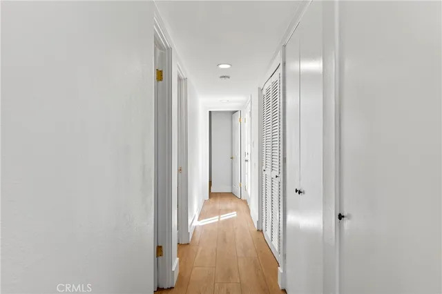 a view of a hallway with wooden floor