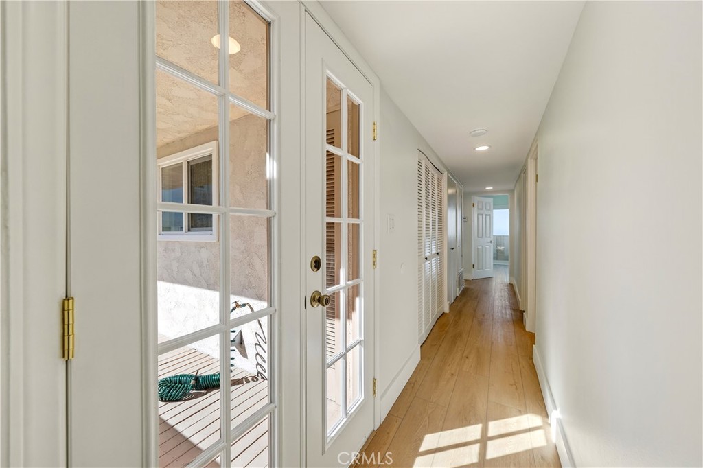 34381 Dana Strand Road, Unit 2 Dana Point, CA 92629 - Photo 18 of 42 a view of a hallway with wooden floor and glass door