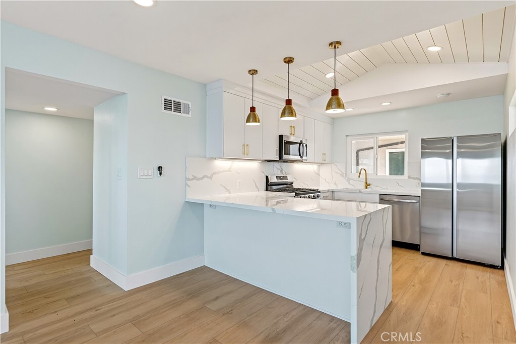 34381 Dana Strand Road, Unit 2 Dana Point, CA 92629 - Photo 3 of 42 a kitchen with a sink a refrigerator and window