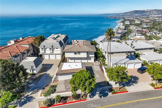 an aerial view of a house with ocean view