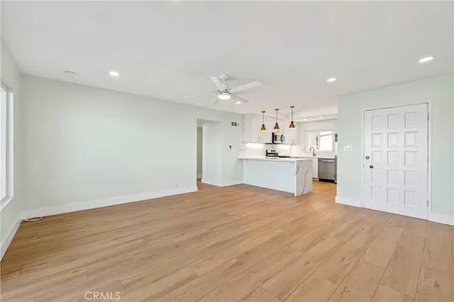 a view of a kitchen with wooden floor and a kitchen