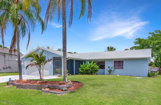 a house with palm tree in front of it