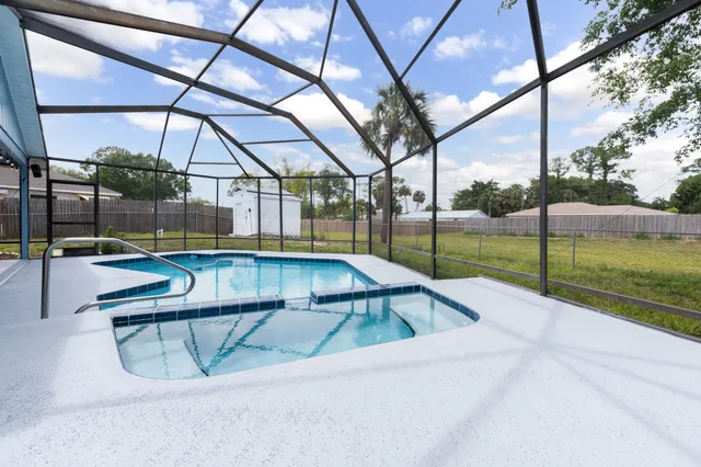 a view of a swimming pool with a backyard