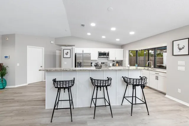 a kitchen with a table and chairs in it