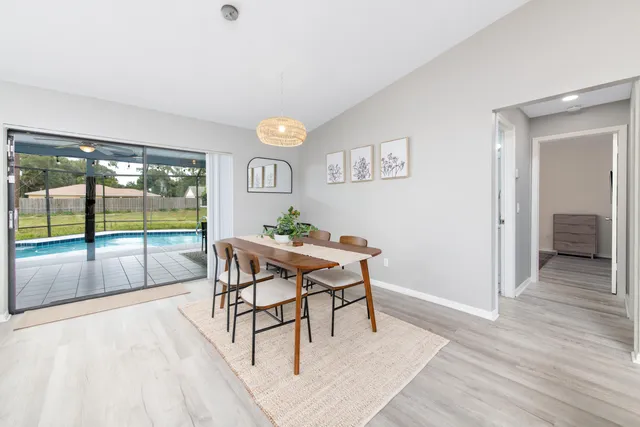 a view of a dining room with furniture and wooden floor