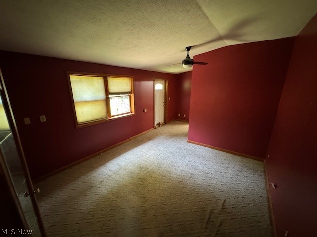 3225 Call Road Perry, OH 44081 - Photo 11 of 14 Unfurnished room featuring a textured ceiling, ceiling fan, lofted ceiling, and carpet flooring