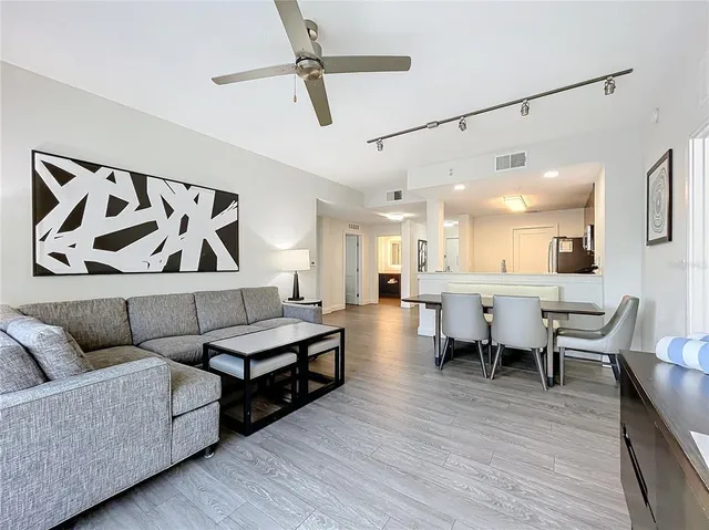 a living room with furniture and wooden floor