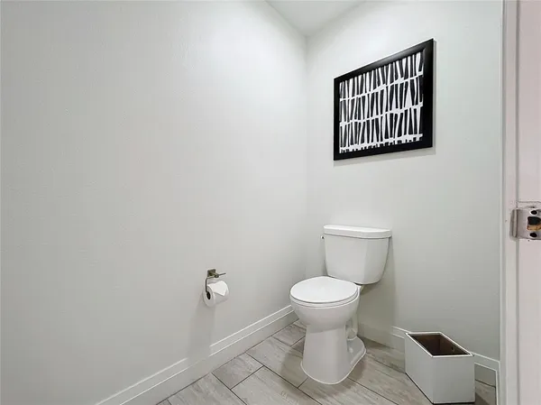 a bathroom with a toilet and a mirror