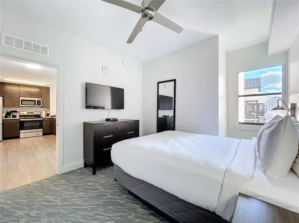 a bedroom with a bed and a flat screen tv