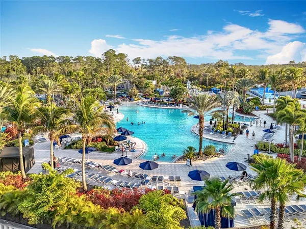 an aerial view of a city with lots of residential buildings ocean and mountain view in back
