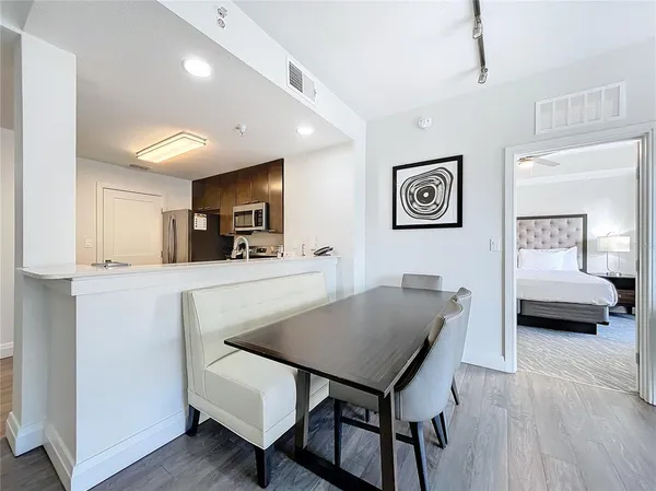 a view of a dining room with furniture and wooden floor