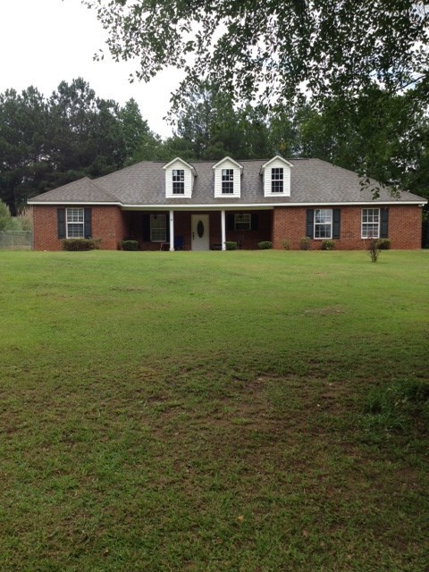 331 Lite-N-Tie Road Gray, GA 31032 - Photo 1 of 15 a front view of a house with a garden