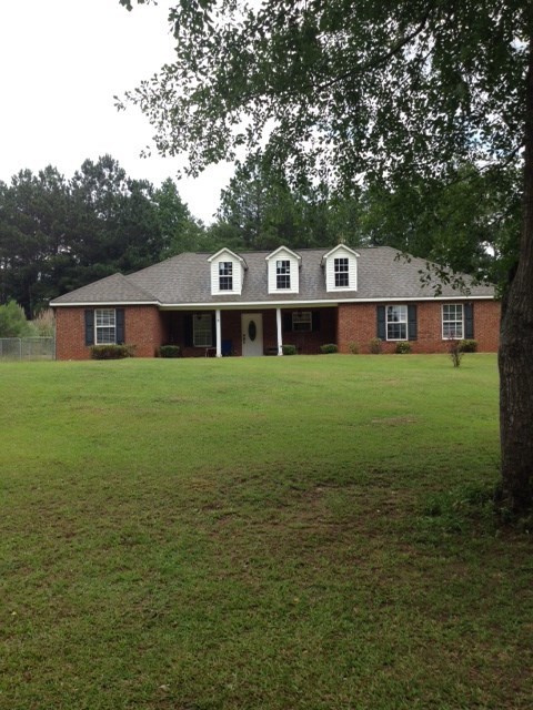 331 Lite-N-Tie Road Gray, GA 31032 - Photo 2 of 15 a front view of a house with garden
