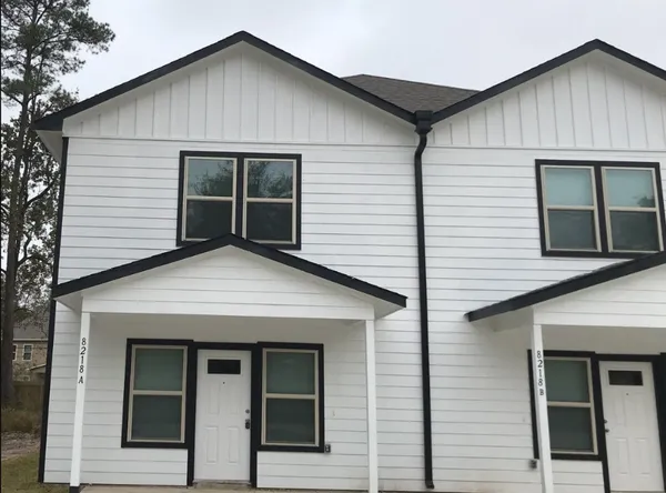 a view of small house with entrance gate