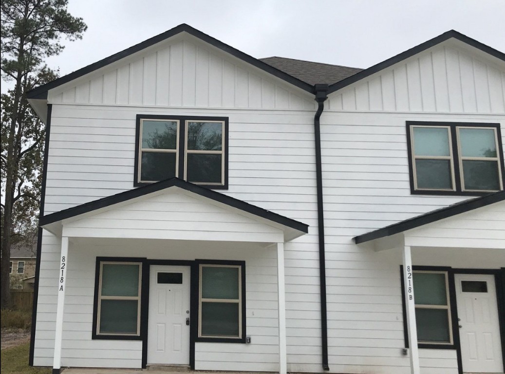 a view of small house with entrance gate