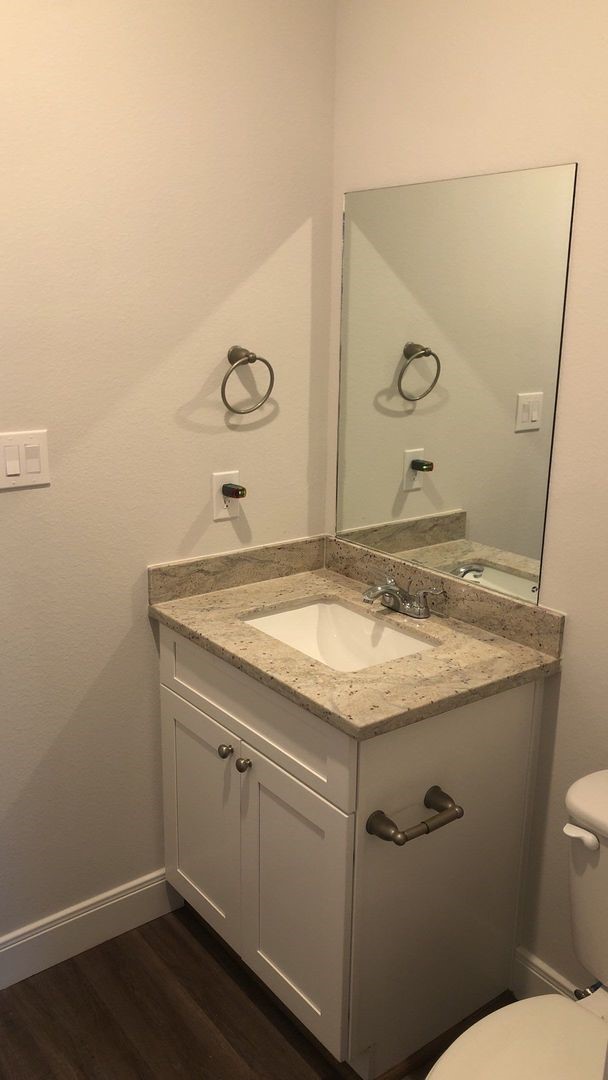 8218 Parker Road, Unit A Houston, TX 77078 - Photo 12 of 18 a bathroom with a granite countertop sink toilet and mirror