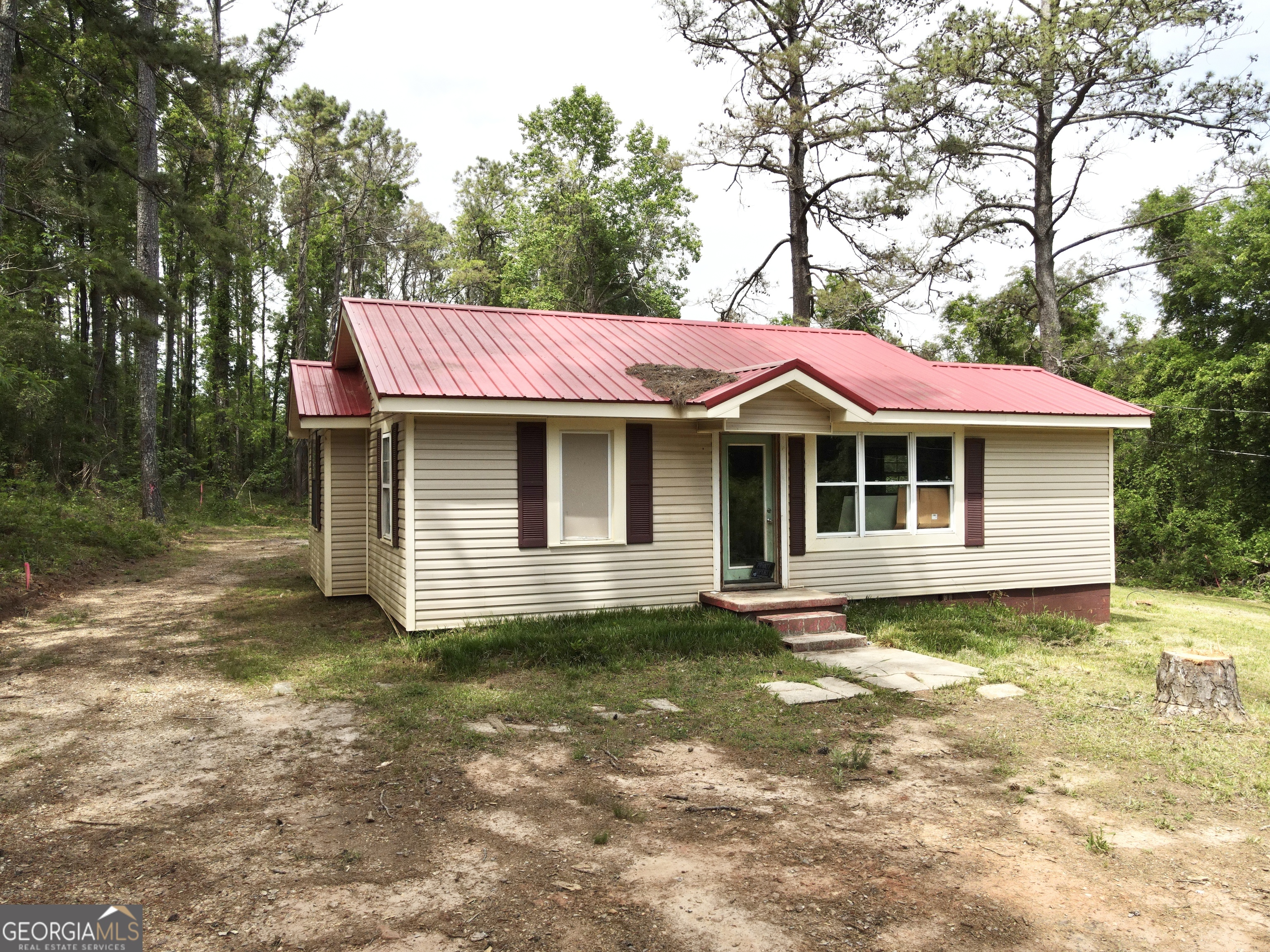 a front view of a house with a garden