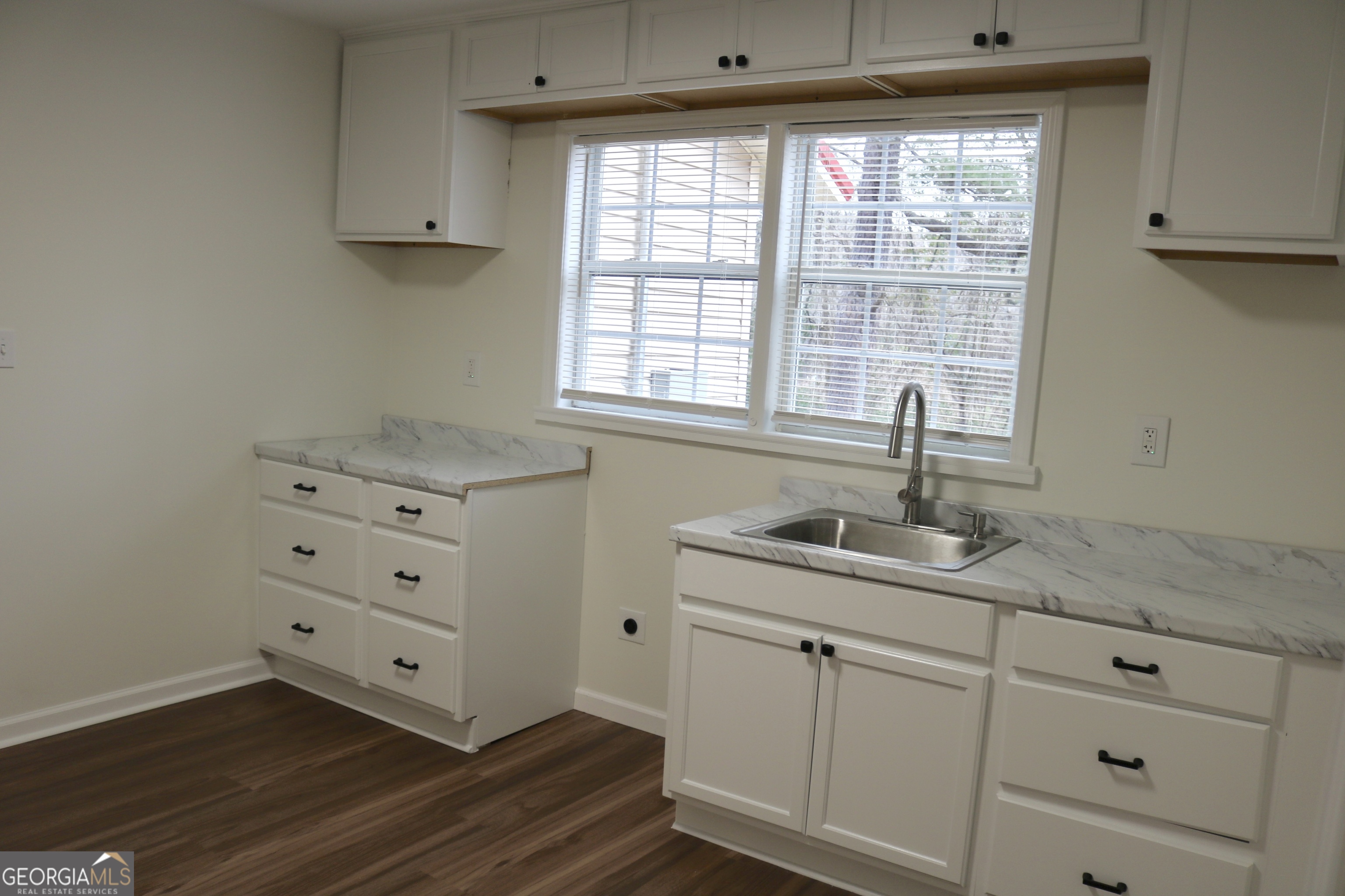 135 Chase Road LaGrange, GA 30241 - Photo 11 of 20 a kitchen with granite countertop white cabinets and a sink