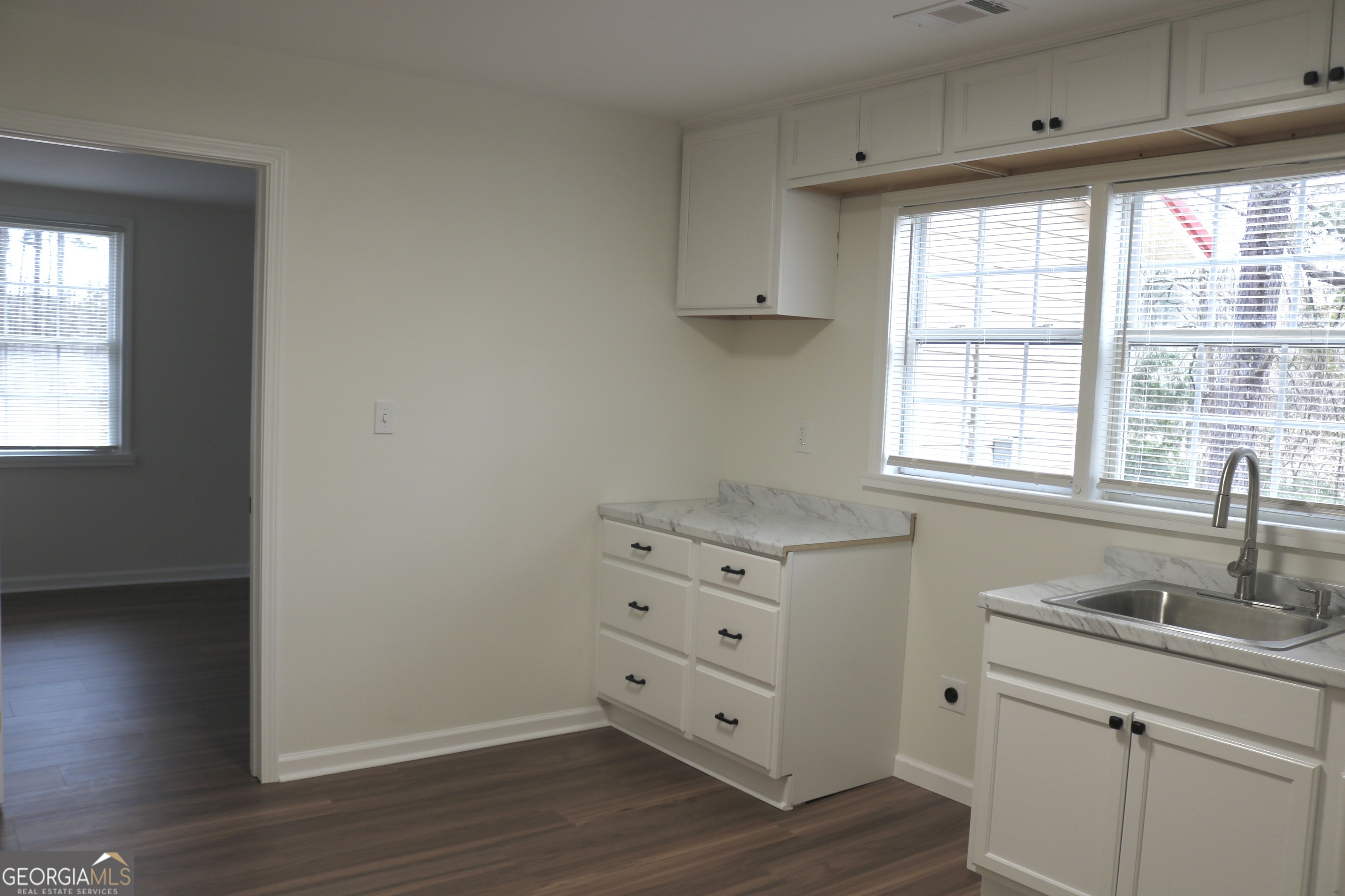 135 Chase Road LaGrange, GA 30241 - Photo 12 of 20 a view of a kitchen with wooden floor and a window