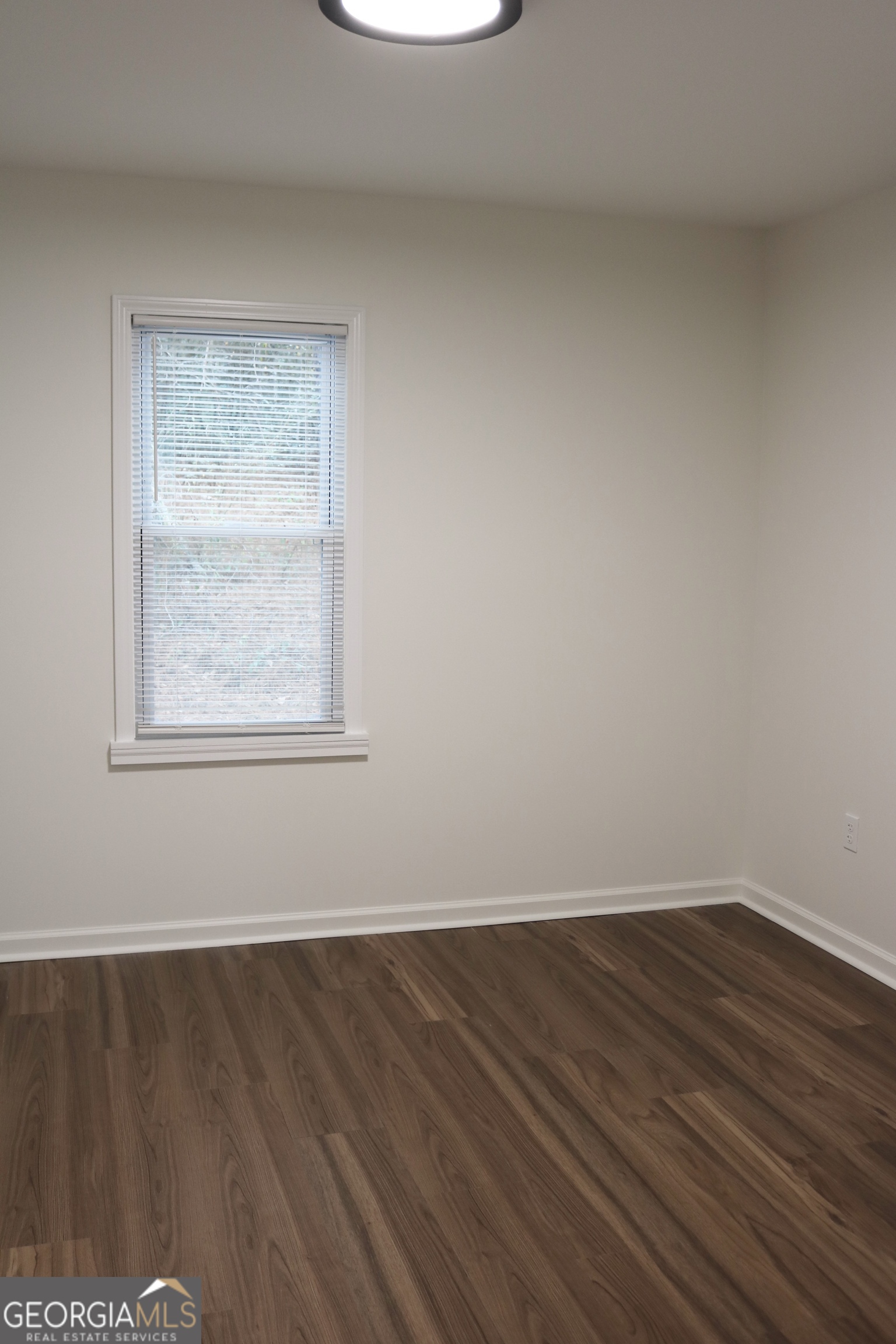 135 Chase Road LaGrange, GA 30241 - Photo 17 of 20 an empty room with wooden floor and windows