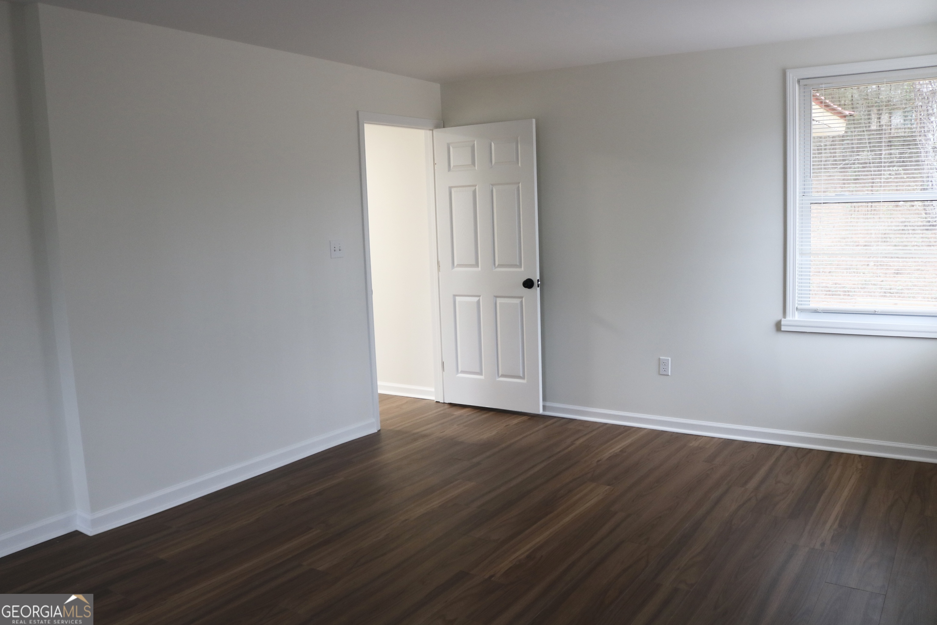 135 Chase Road LaGrange, GA 30241 - Photo 18 of 20 an empty room with wooden floor and windows