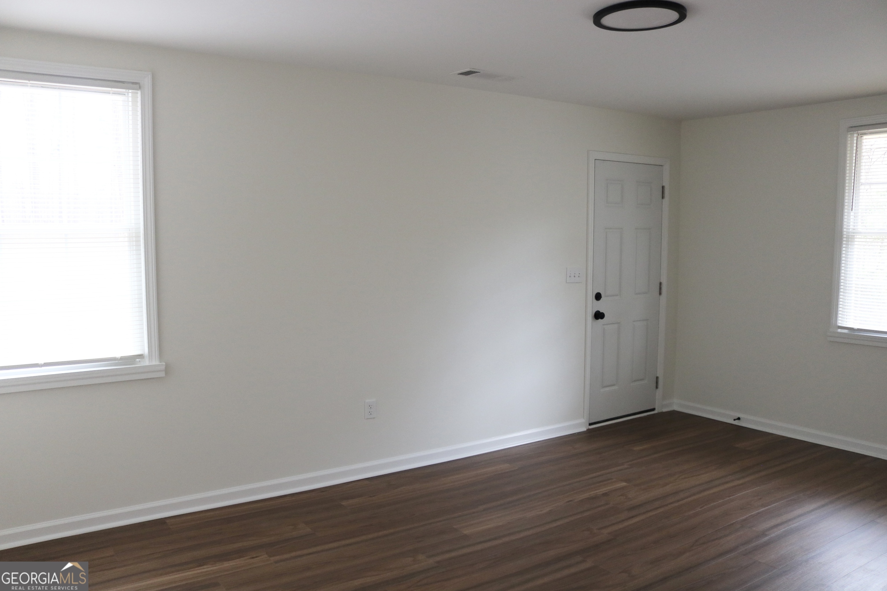 135 Chase Road LaGrange, GA 30241 - Photo 19 of 20 an empty room with wooden floor and windows