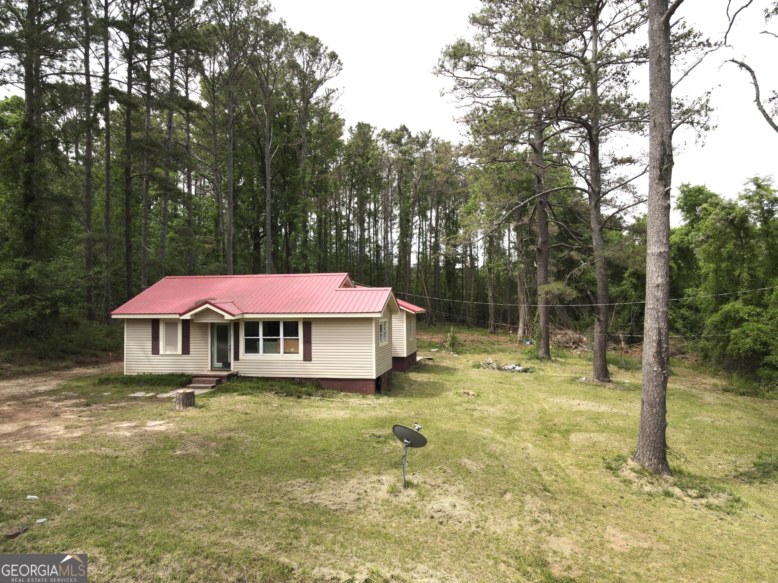 135 Chase Road LaGrange, GA 30241 - Photo 2 of 20 a blue swimming pool is in front of a house