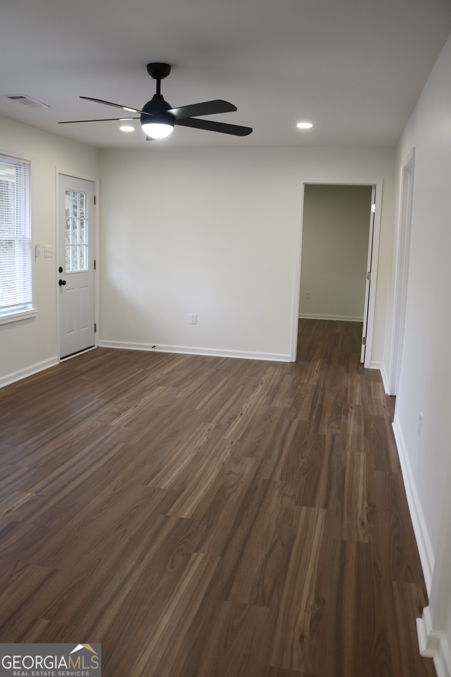 135 Chase Road LaGrange, GA 30241 - Photo 8 of 20 wooden floor in an empty room with a window