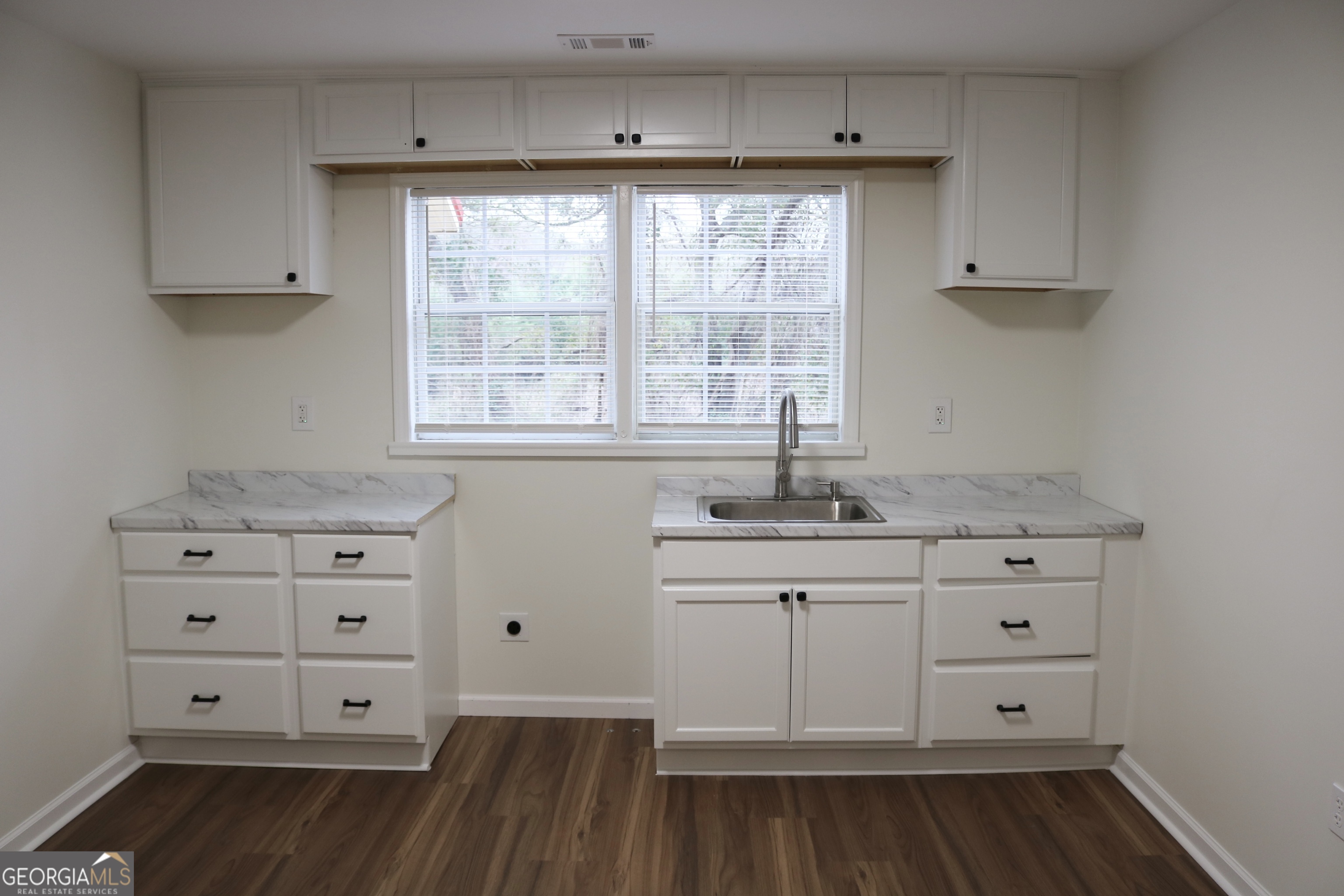 135 Chase Road LaGrange, GA 30241 - Photo 10 of 20 a kitchen with cabinets appliances and a window