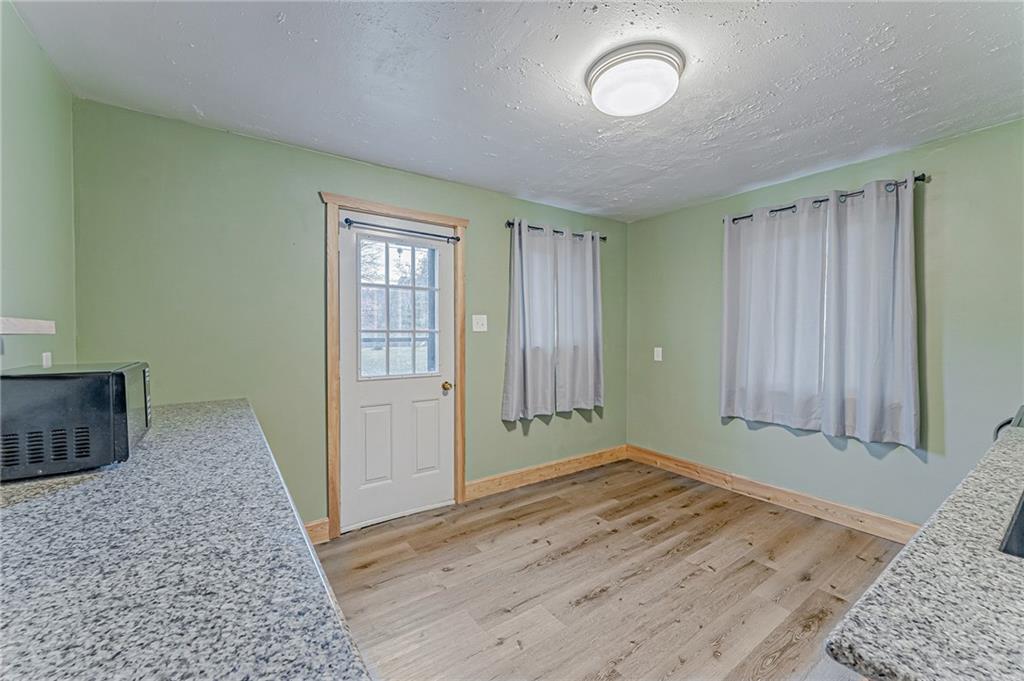 67 Noblestown Road Carnegie, PA 15106 - Photo 12 of 24 an empty room with wooden floor and windows