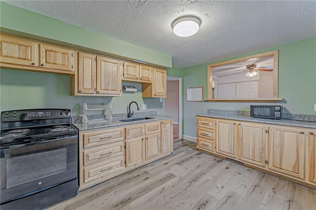 67 Noblestown Road Carnegie, PA 15106 - Photo 13 of 24 a kitchen with granite countertop white cabinets and stainless steel appliances