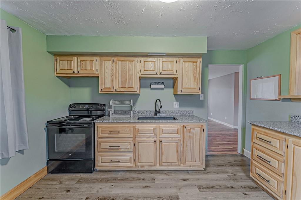67 Noblestown Road Carnegie, PA 15106 - Photo 14 of 24 a kitchen with a stove and a sink