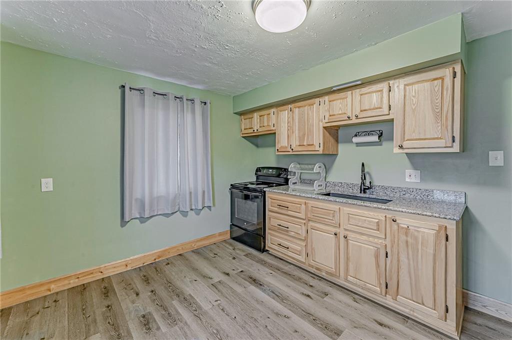 67 Noblestown Road Carnegie, PA 15106 - Photo 15 of 24 a kitchen with granite countertop a sink cabinets stainless steel appliances and a window
