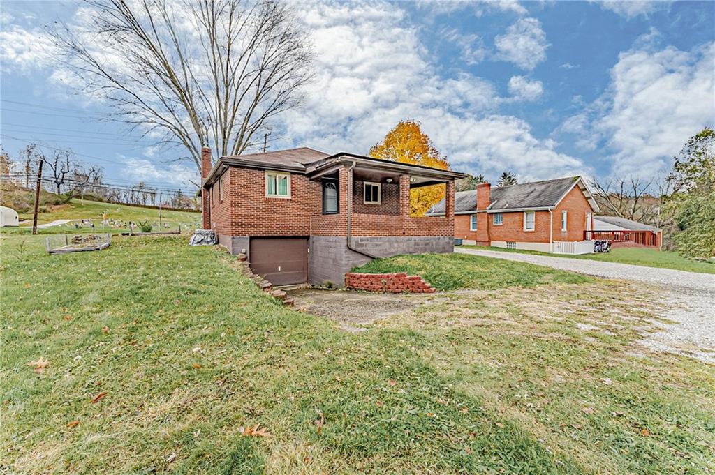 67 Noblestown Road Carnegie, PA 15106 - Photo 24 of 24 a front view of a house with yard and green space