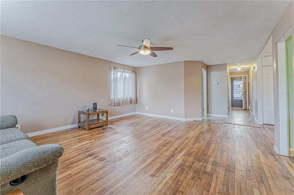 67 Noblestown Road Carnegie, PA 15106 - Photo 7 of 24 a view of an empty room with window and wooden floor