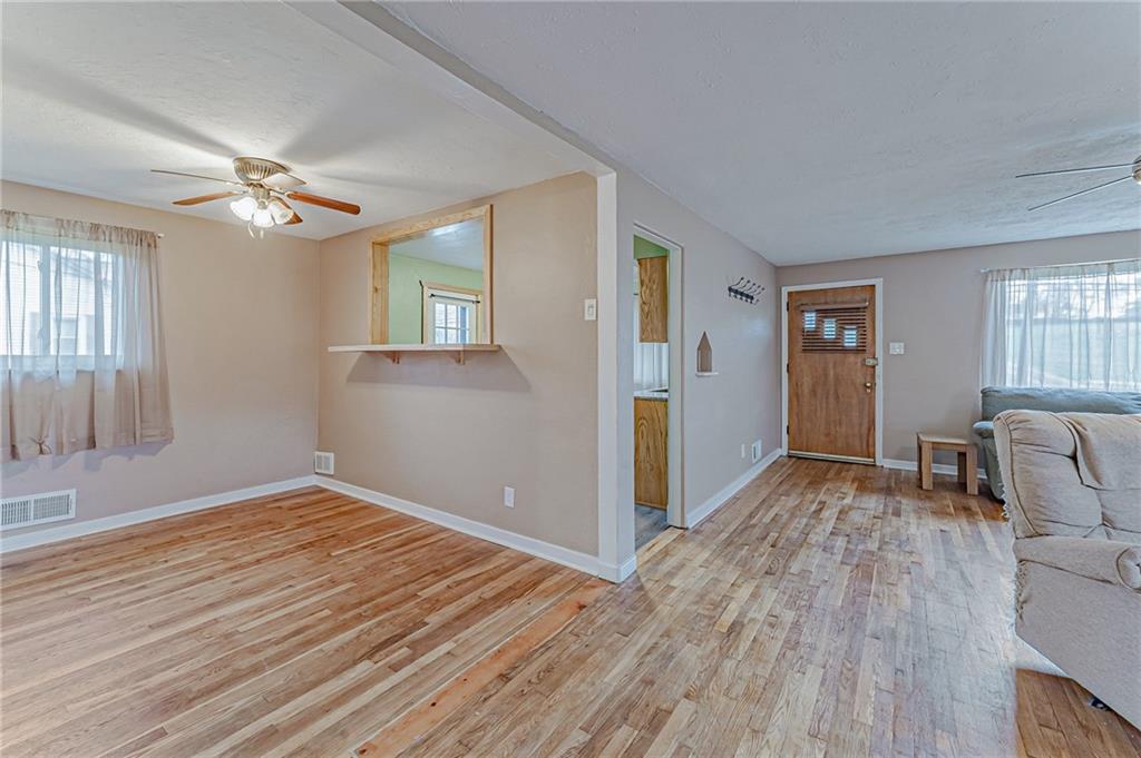 67 Noblestown Road Carnegie, PA 15106 - Photo 8 of 24 a view of empty room with wooden floor and fan