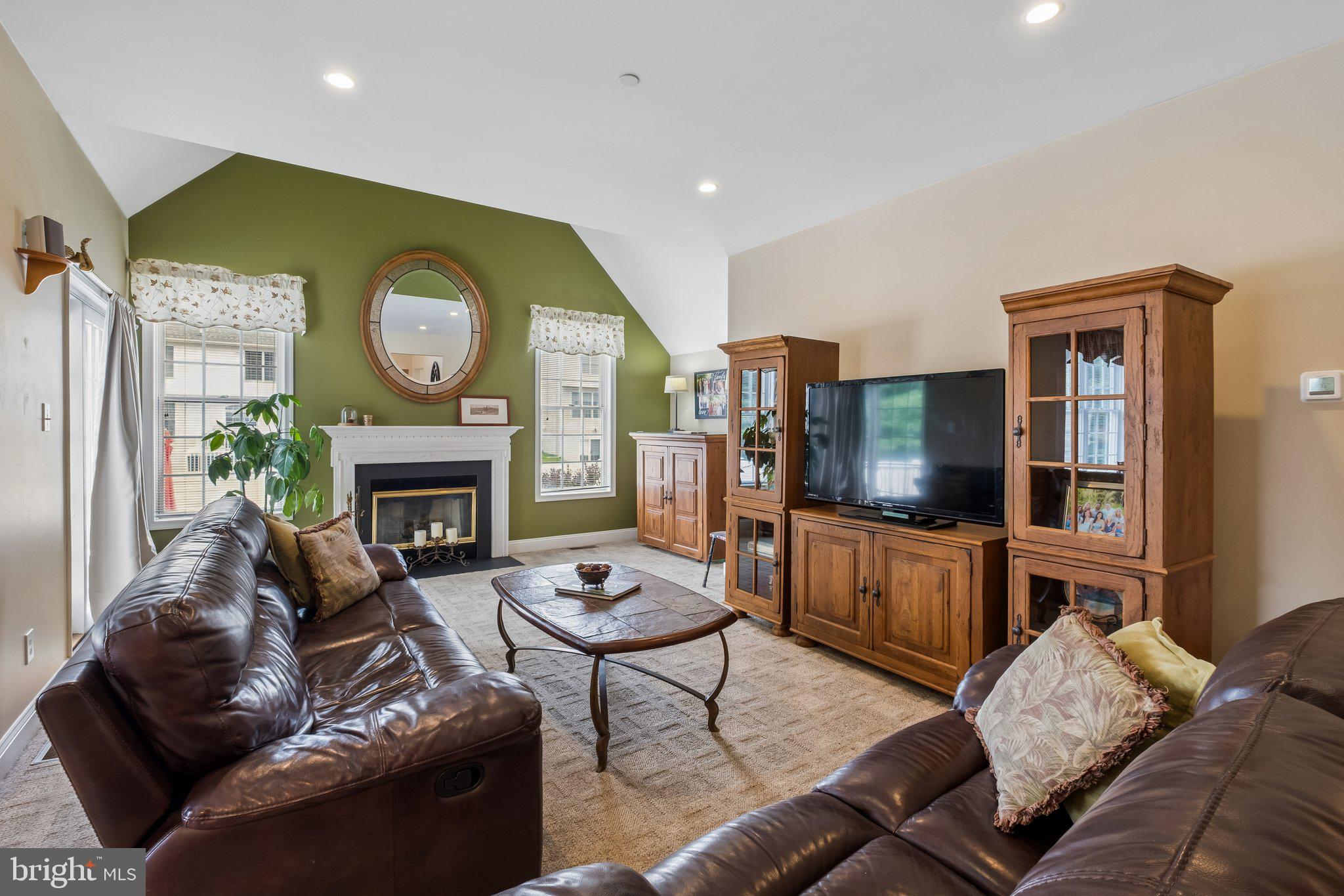305 Langford Road Broomall, PA 19008 - Photo 20 of 83 a living room with furniture a fireplace and a flat screen tv
