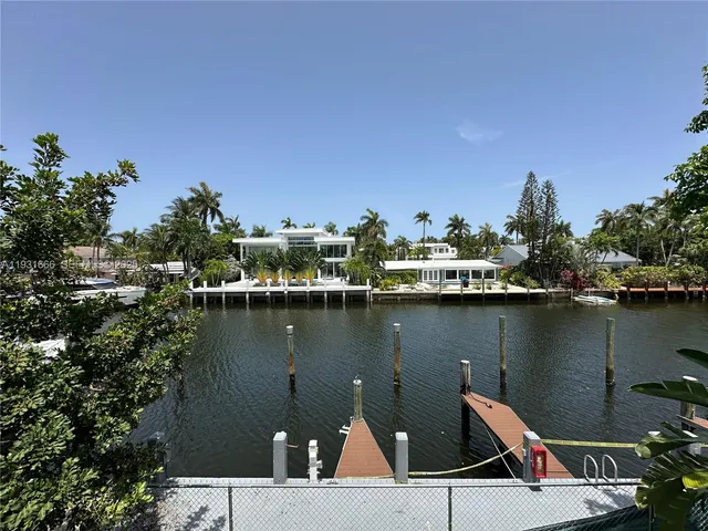 a view of a lake with boats and trees in the background