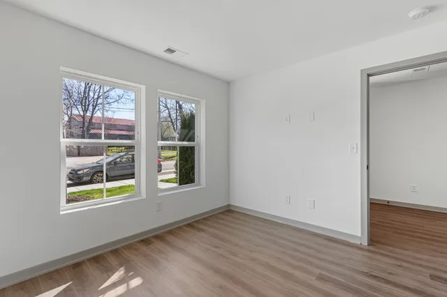 a view of a hallway with wooden floor and entryway