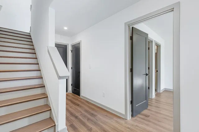 a bathroom with a granite countertop toilet a sink a mirror and bathtub