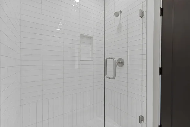 a view of an empty room with wooden floor and closet