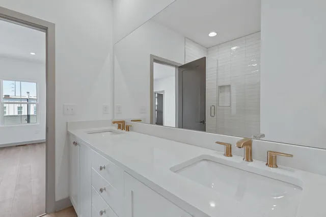 a kitchen with stainless steel appliances a stove a sink and a wooden floor
