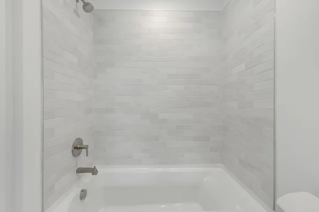 a view of an empty room with wooden floor and closet