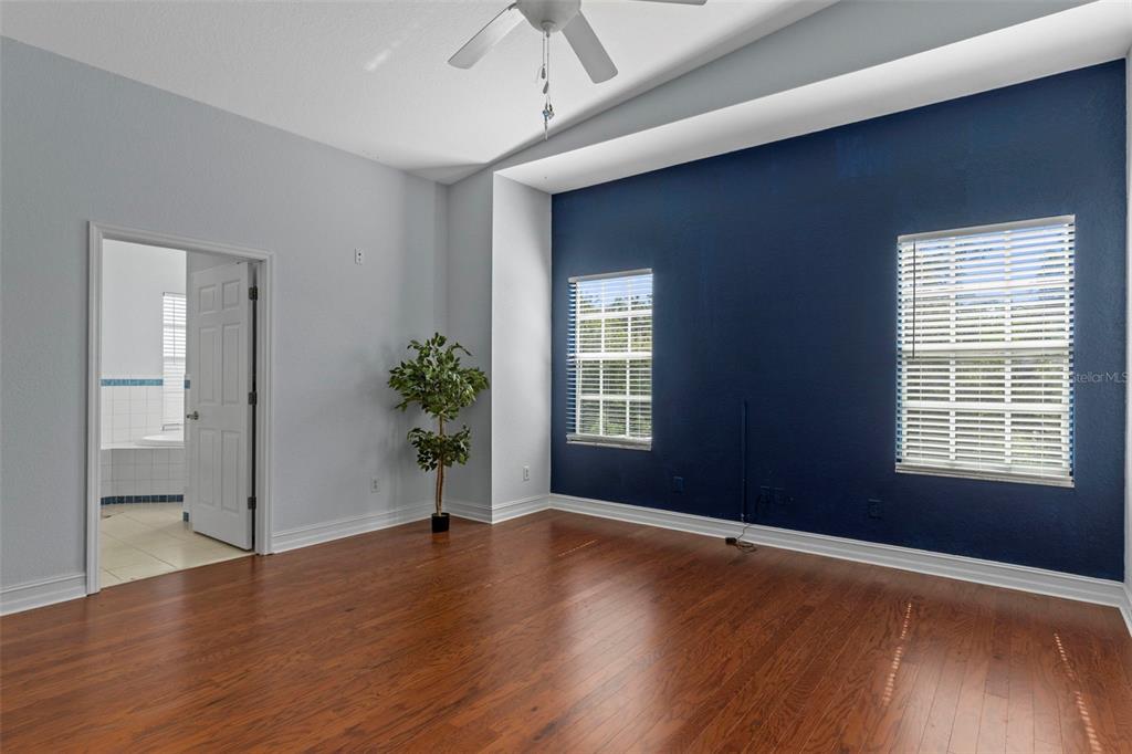 8229 Gulf Way Hudson, FL 34667 - Photo 20 of 35 a view of an empty room with wooden floor and a window